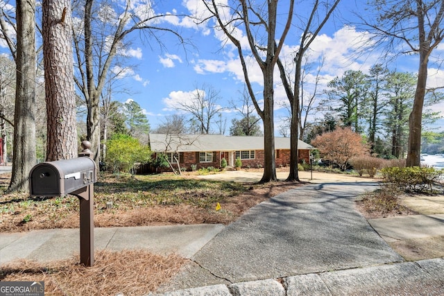 view of front of house featuring brick siding and driveway