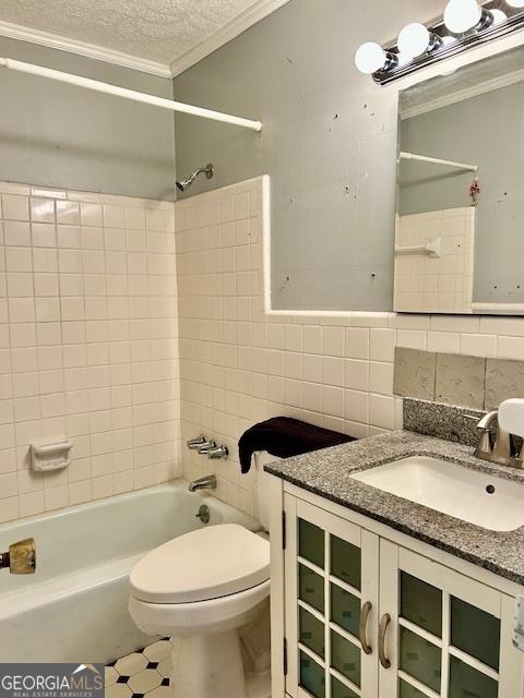 bathroom featuring crown molding, shower / bath combination, tile walls, and a textured ceiling