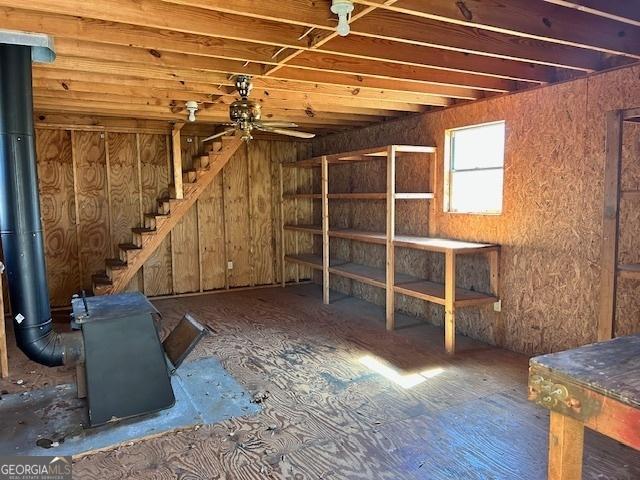 basement featuring stairway and a ceiling fan