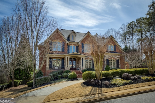 view of front of home with brick siding and stone siding