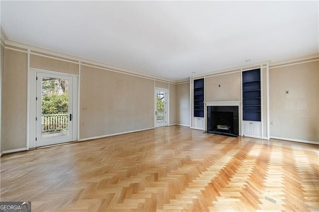 unfurnished living room with a fireplace, baseboards, and ornamental molding