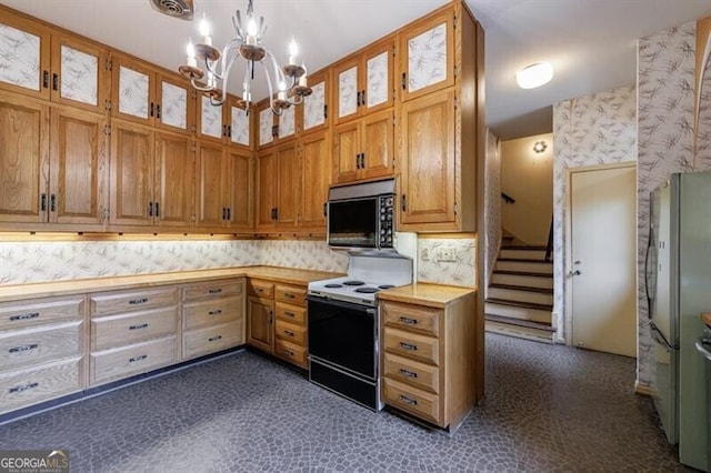 kitchen featuring brown cabinets, range with electric stovetop, an inviting chandelier, light countertops, and glass insert cabinets