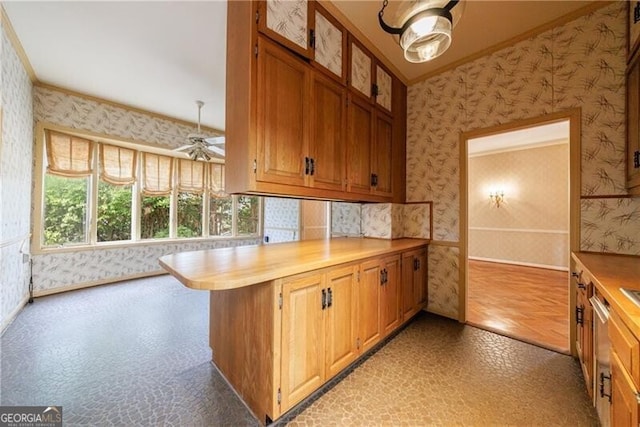 kitchen featuring light floors, a ceiling fan, wallpapered walls, a peninsula, and light countertops