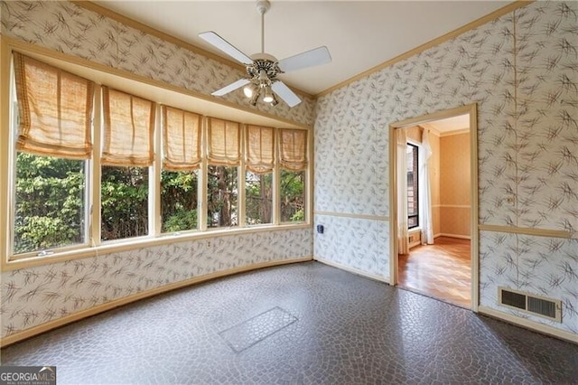 interior space with visible vents, a healthy amount of sunlight, and wallpapered walls