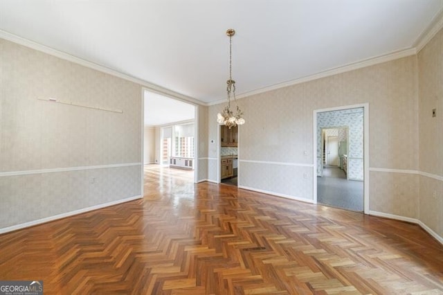 unfurnished room with baseboards, a chandelier, crown molding, and wallpapered walls