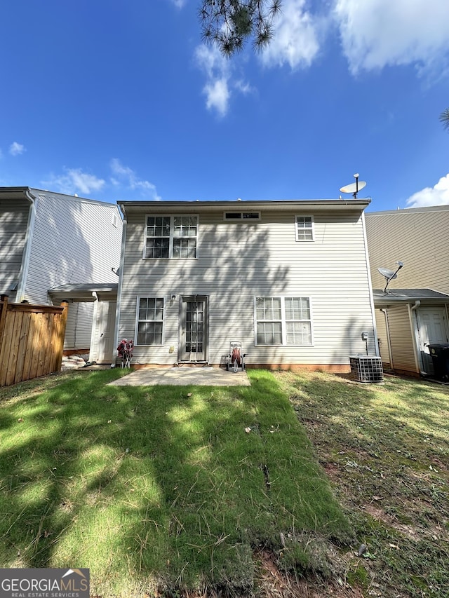 back of house with fence, a lawn, and a patio area