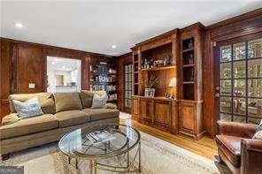 living area with wood finished floors and wood walls