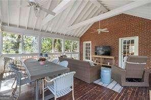 sunroom featuring a healthy amount of sunlight, lofted ceiling with beams, and ceiling fan