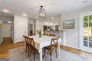 dining area with baseboards and wood finished floors