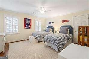 bedroom featuring baseboards, ceiling fan, and crown molding