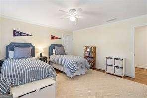 bedroom featuring wood finished floors, ceiling fan, and ornamental molding