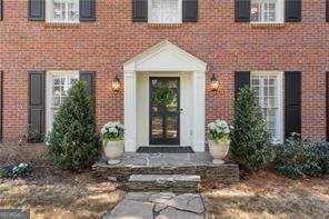 doorway to property with brick siding