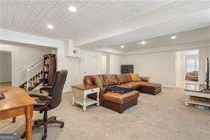 living area featuring stairs, recessed lighting, ornamental molding, and carpet flooring