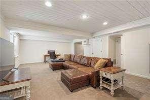 carpeted living area with recessed lighting