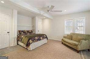 carpeted bedroom with a ceiling fan