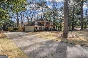 traditional-style home with an attached garage and driveway