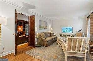 interior space featuring wood finished floors and ornamental molding