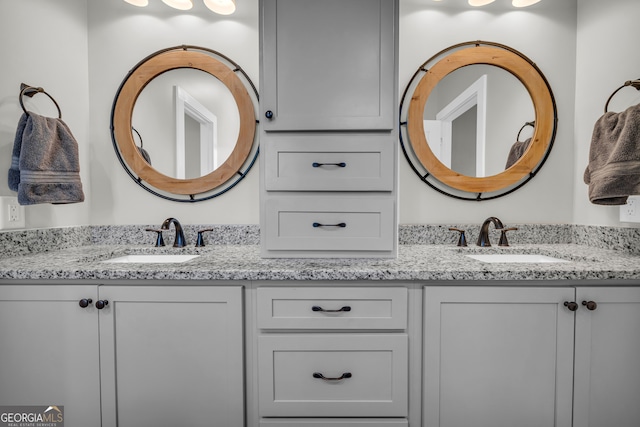 full bath with double vanity and a sink