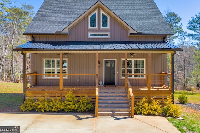 rustic home with a porch, a shingled roof, and metal roof