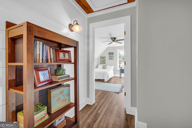 hall with wood finished floors and baseboards