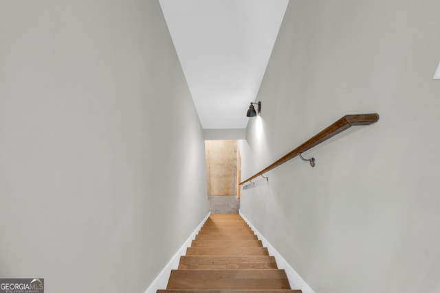 stairs featuring baseboards and wood finished floors