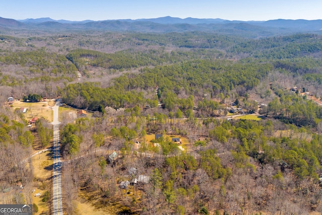 birds eye view of property with a mountain view and a view of trees