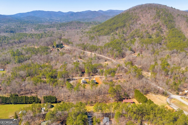 birds eye view of property with a view of trees and a mountain view