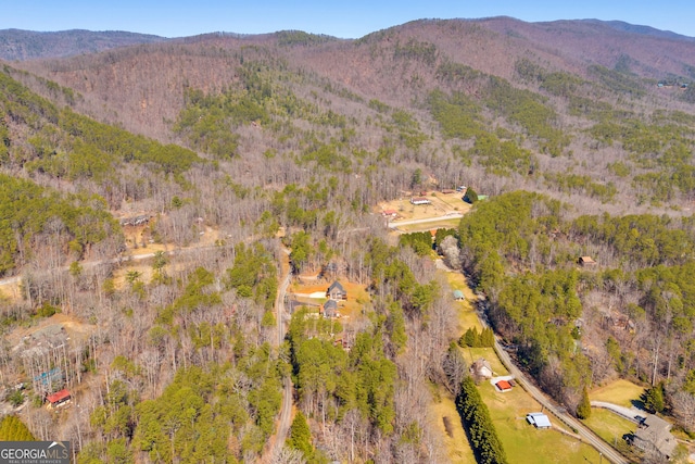 drone / aerial view featuring a mountain view and a forest view