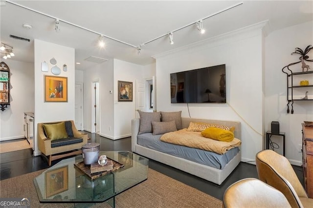 living room with track lighting and baseboards