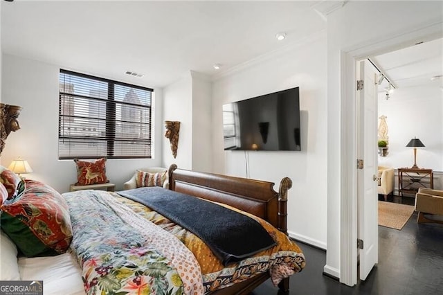 bedroom with baseboards and visible vents