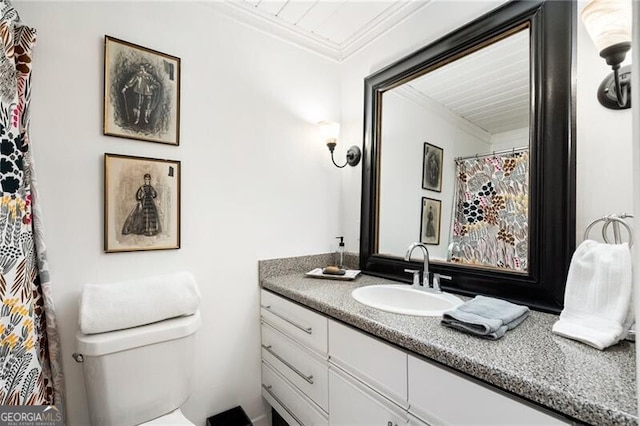 full bathroom with toilet, vanity, and ornamental molding