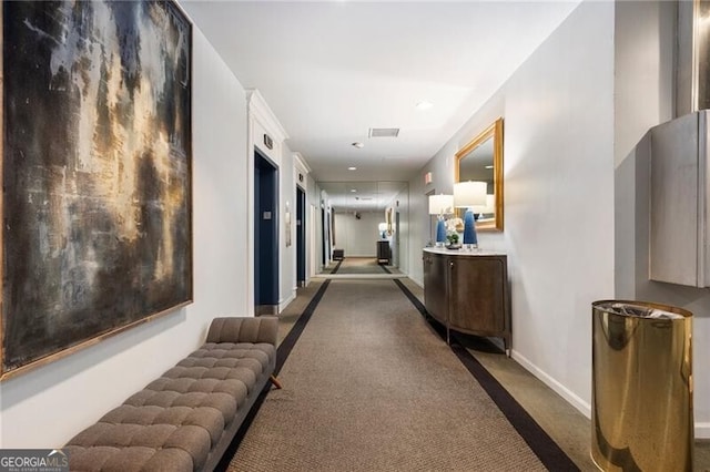 corridor featuring visible vents and baseboards