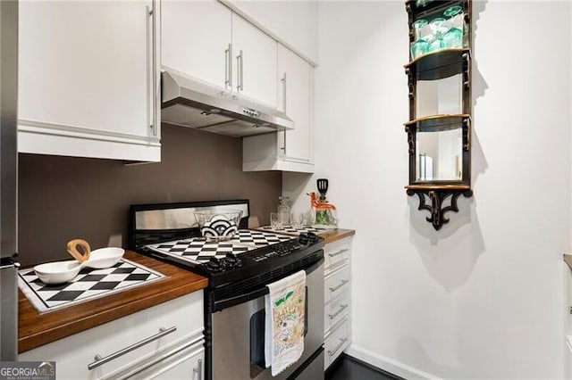 kitchen featuring under cabinet range hood, gas range, white cabinets, and wooden counters