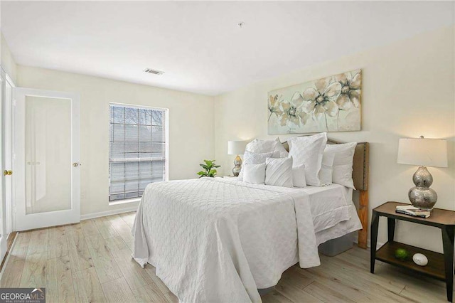 bedroom with visible vents and light wood finished floors