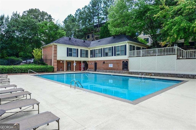 pool featuring a patio area and fence