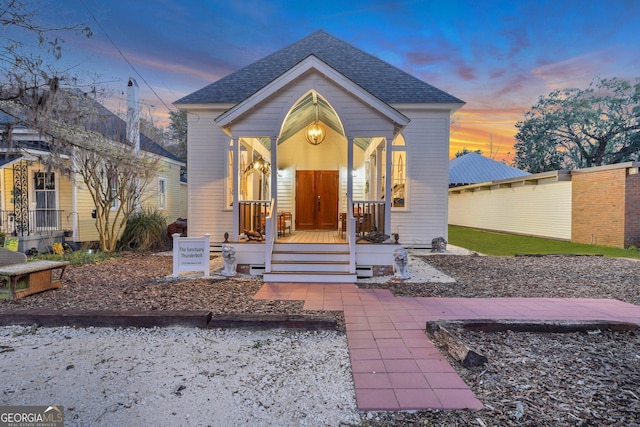 view of front of home featuring a porch and roof with shingles