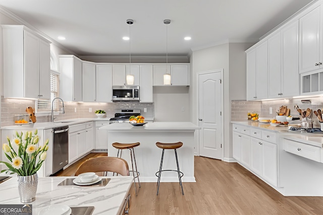 1900 Sanborne Way, Dacula, GA 30019 - kitchen with stainless steel appliances, a sink, backsplash, ornamental molding, and white cabinetry