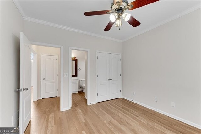 unfurnished bedroom with light wood-style flooring, ensuite bathroom, ornamental molding, a closet, and baseboards
