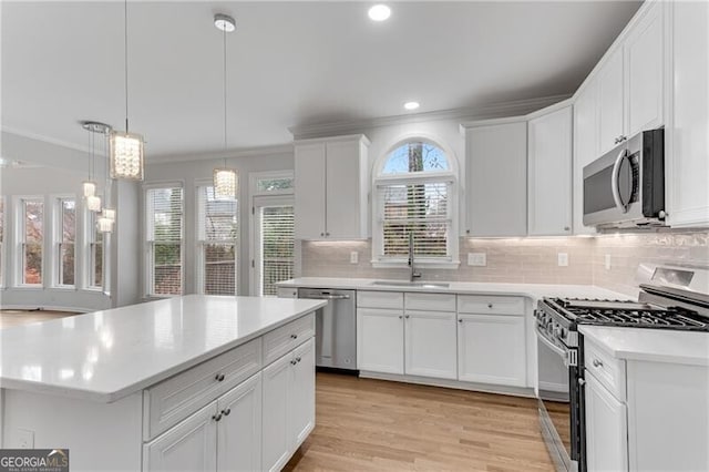 1900 Sanborne Way, Dacula, GA 30019 - kitchen featuring appliances with stainless steel finishes, a sink, ornamental molding, light countertops, and white cabinets