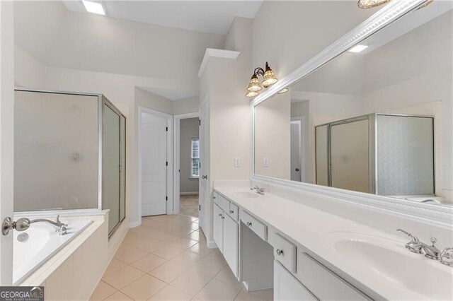 bathroom with double vanity, a stall shower, a sink, tile patterned flooring, and a bath