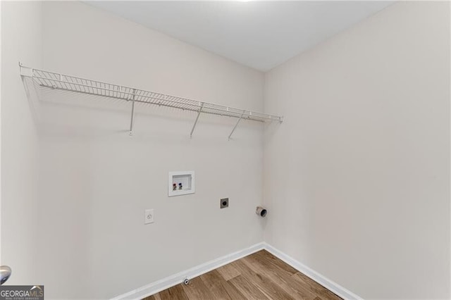 washroom featuring hookup for a washing machine, wood finished floors, baseboards, laundry area, and electric dryer hookup