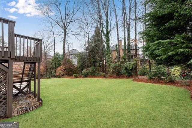 view of yard featuring a wooden deck and stairs
