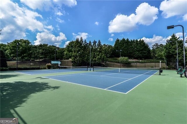 view of tennis court with fence