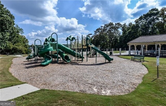 community play area with a yard and fence