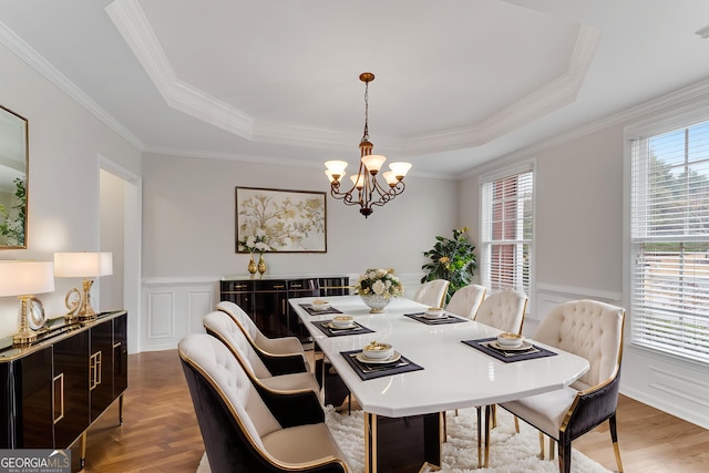 1900 Sanborne Way, Dacula, GA 30019 - dining area featuring a raised ceiling, a chandelier, a wainscoted wall, a decorative wall, and ornamental molding