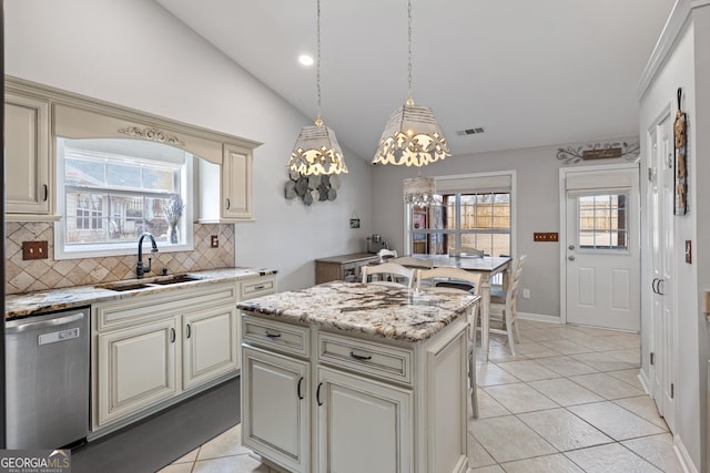 kitchen featuring a sink, visible vents, stainless steel dishwasher, and cream cabinets