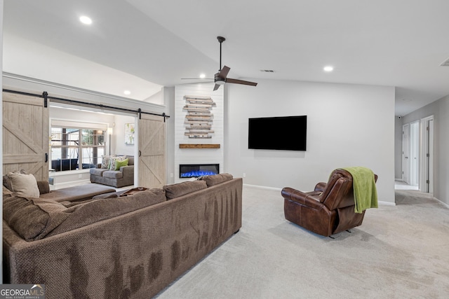 living room featuring a barn door, recessed lighting, carpet, and vaulted ceiling