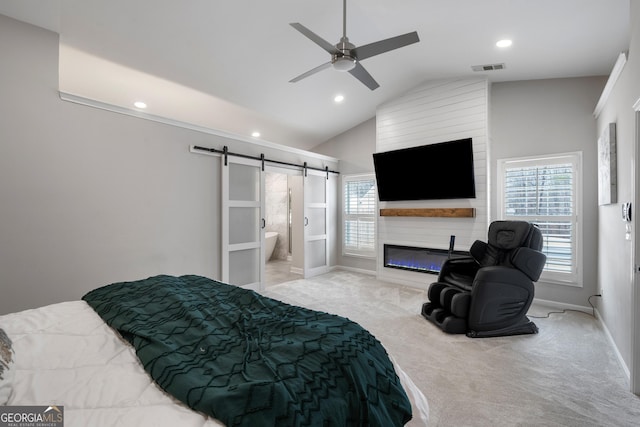 bedroom featuring a barn door, a large fireplace, carpet flooring, baseboards, and vaulted ceiling