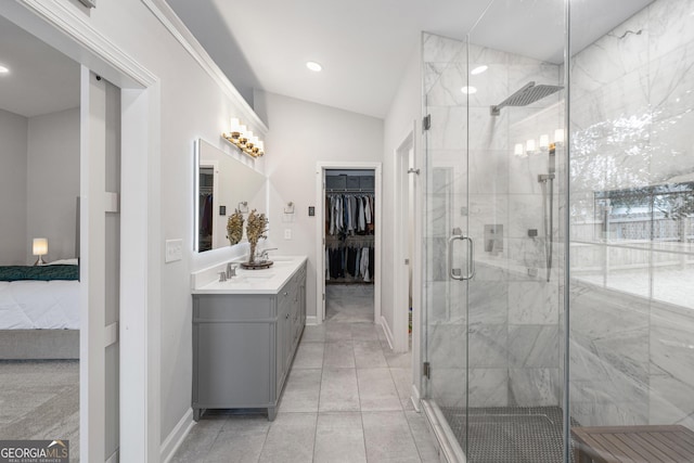 bathroom with vanity, a shower stall, a walk in closet, and recessed lighting