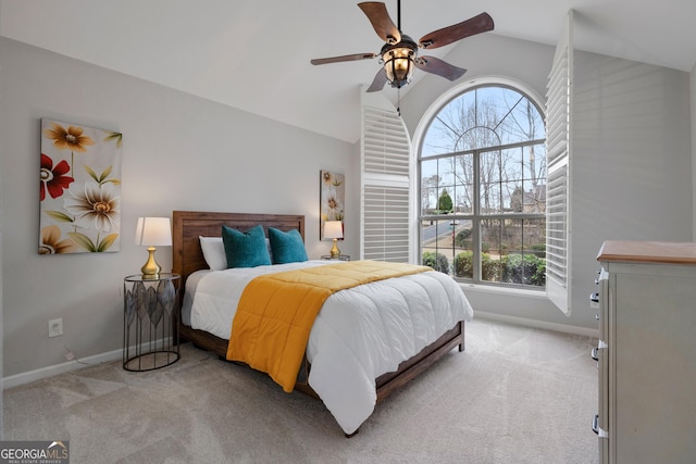 bedroom with light colored carpet, baseboards, and ceiling fan